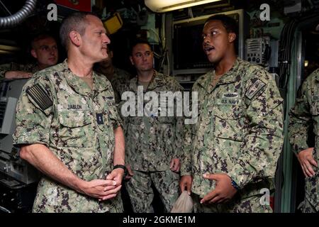 SANTA RITA, Guam (May 26, 2021) Fire Control Technician 1st Class Bryan Cooper (right) meets with Rear Adm. Jeff Jablon (left), commander, Submarine Force, U.S. Pacific Fleet, in control during a tour of the Los Angeles-class fast-attack submarine USS Key West (SSN 722). Jablon visited Key West and other units at Naval Base Guam to meet with Sailors, discuss unit operations with leadership, and assess area capabilities first-hand. Stock Photo