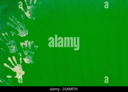 White paint hand print on green metal wall texture. Stock Photo