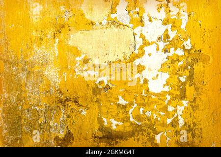 Yellow old dirty concrete cracked wall texture or background Stock Photo