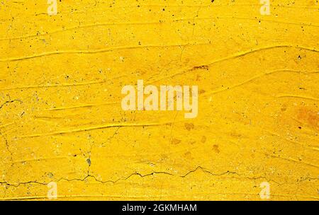 Yellow painted old dirty concrete wall texture or background Stock Photo