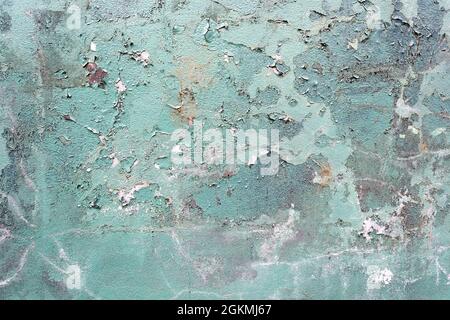 Green concrete cracked painted damaged grunge wall background or texture Stock Photo