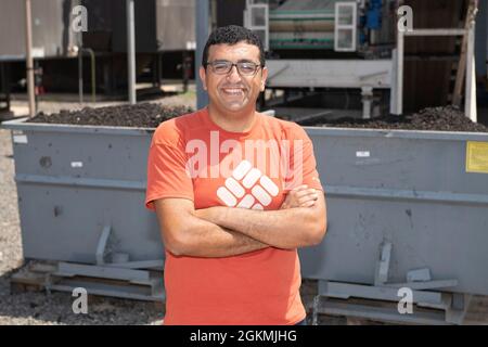 CAMP LEMONNIER, Djibouti (May 27, 2021) Camp Lemonnier’s Installation Energy Manager, Mina Magdy, of Cairo, Egypt, poses in front of the solids accumulated after wastewater treatment at Camp Lemonnier, on May 27, 2021. Camp Lemonnier is an operational installation that enables U.S., allied and partner nation forces to be where and when they are needed to ensure security in Europe, Africa and Southwest Asia. Stock Photo