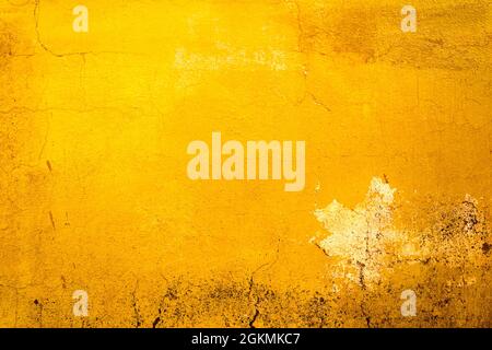 Yellow painted old dirty concrete wall texture or background Stock Photo
