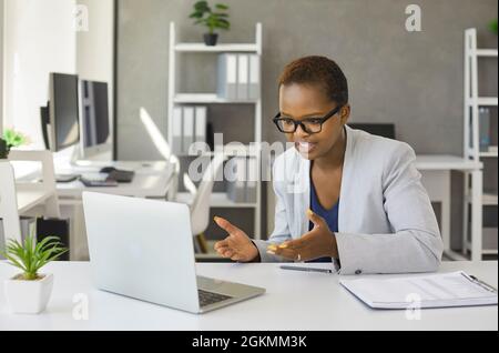Black businesswoman having an online meeting via a video call on her laptop computer Stock Photo