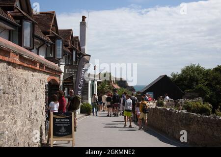 Holiday makers on a sunny day at Lulworth Cove in Dorset in the UK Stock Photo
