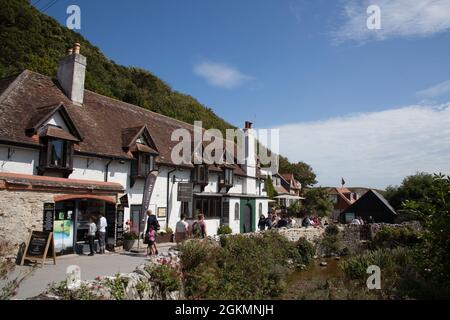 Holiday makers on a sunny day at Lulworth Cove in Dorset in the UK Stock Photo