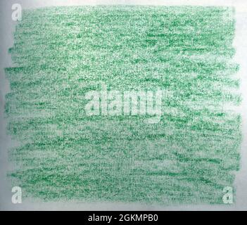 Crayon scribble background in green tones on white paper. Stock Photo