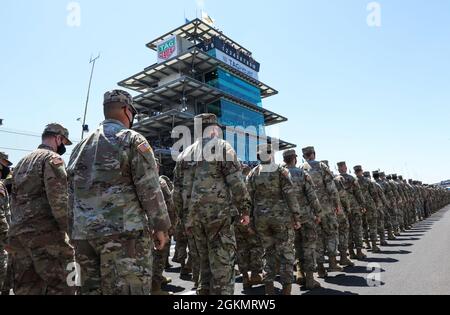Indiana National Guard members and sister services march down the Indianapolis Motor Speedway during the opening ceremonies of the Indianapolis 500, May 30, 2021. For two weeks leading up to the Indianapolis 500, multiple events took place to honor military service members and their families. Stock Photo