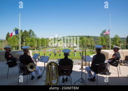 1st Marine Division band members observe a ceremony at Aisne-Marne American Cemetery in Belleau, France, May 30, 2021. The ceremony was held Memorial Day weekend in commemoration of the 103rd anniversary of the battle of Belleau Wood, conducted to honor the legacy of service members who gave their lives in defense of the United States and European allies. U.S. Marines and Sailors from Marine Corps Forces Europe and Africa, 5th Marine Regiment, 6th Marine Regiment, 1st Marine Division band, U.S. Soldiers from the Army 26th Infantry Division, 2nd Infantry Division representatives, German and Fre Stock Photo
