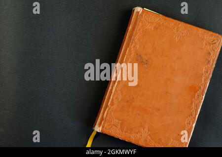 Very old worn notebook in brown leather binding. Vintage book on Stock Photo