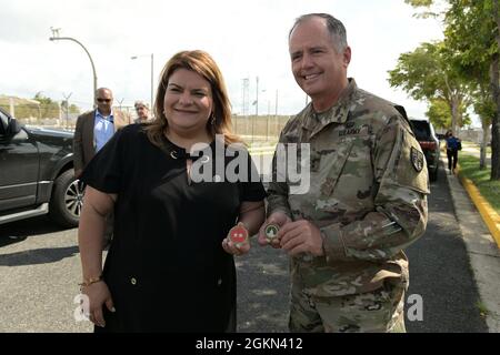 U.S. Congresswoman Jenniffer González-Colon, the Resident Commissioner for Puerto Rico and U.S. Army Maj. Gen. Jose Reyes, the Adjutant General, Puerto Rico, present organization coins to each other, June 2, 2021. During her visit she met with leadership to discuss MILCON projects and to get a personal look at base operations. Stock Photo