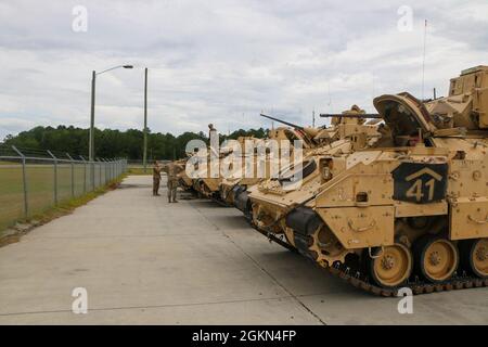 Cavalrymen assigned to 6th Squadron, 8th Cavalry Regiment, 2nd Armored Brigade Combat Team, 3rd Infantry Division, conducts preventative maintenance and checks on their Bradley prior to conducting Table III dry-fire during crew gunnery on Fort Stewart, Georgia, June 2, 2021. Gunnery tables train Bradley crews to control and distribute direct fire to engage enemy targets in a tactical environment. Stock Photo