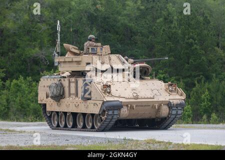 Cavalrymen assigned to 6th Squadron, 8th Cavalry Regiment, 2nd Armored Brigade Combat Team, 3rd Infantry Division, wait to begin the Table III dry-fire iteration for their Bradley crew gunnery at Fort Stewart, Georgia, June 2, 2021. Gunnery tables train gunnery crews to control and distribute direct fire to engage enemy targets in a tactical environment. Stock Photo