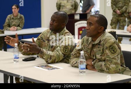 Lt. Gen. R. Scott Dingle (left), the Army Surgeon General and Commanding General of United States Army Medical Command and Command Sgt. Maj. Diamond Hough (right), the Army Medical Command sergeant major, talk to Soldiers from the 30th Medical Brigade during their visit to the European Theater at Baumholder Germany, June 3, 2021. The Army’s senior medical leadership team observed the 30th MED BDE’s Hospital Exercise 21 which served to certify the 519th Hospital center as a NATO role 2 enhanced capability. Approximately 400 personnel from the 30th Medical Brigade, U.S. Air Force, U.S. Army Rese Stock Photo