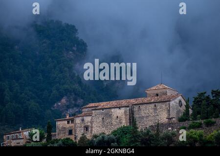 Clouds in the hills behind the Church of Sant Joan, Deià, Mallorca, Spain Stock Photo