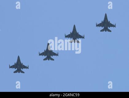 Four U.S. Air Force F-16 Fighting Falcons assigned to the 555th Fighter Squadron participating in Falcon Strike 21 (FS21) fly in formation over Amendola Air Base, Italy, June 4, 2021. Six U.S. Air Force F-16C aircraft are participating in Falcon Strike 21 (FS21), an exercise involving service members from the U.S., Israel, Italy and the United Kingdom to integrate fourth and fifth generation fighter capabilities in a large force employment event. Exercises like FS21 provide a venue to train with other nations, build readiness, practice interoperability, and enhance enduring relationships. Stock Photo