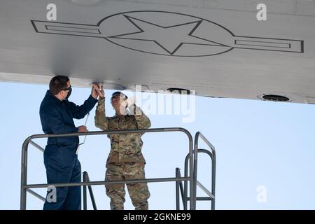 U.S. Air Force Staff Sgt. Tyler Coons, left, 60th Maintenance Squadron aerospace repair team leader, and Senior Airman Eric Vu, 349th Maintenance Squadron crew chief, install a wing panel on a C-5M Super Galaxy June 4, 2021, Travis Air Force Base, California. The C-5 is the largest aircraft in the Air Force inventory and has a wingspan of 222 feet and 9 inches. Stock Photo