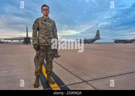 U.S. Air Force Airman 1st Class Casey Tabb, 317th Aircraft Maintenance Squadron crew chief, stands in front of dozens of C-130 airframes prior to their take-off for a class 21A Weapons Instructor Course culmination exercise at Dyess Air Force Base, Texas, June 5, 2021. Air Force crew chiefs are integral to the flying mission, ensuring safety and optimal performance for pilots and aircrews’ missions. Stock Photo