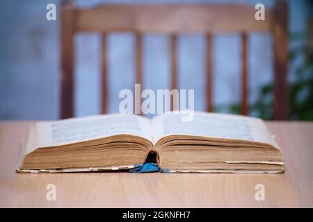 An open book on a wooden table. Selective focus Stock Photo