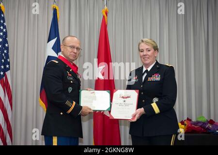 Col. Billie Heiser is presented an award by Maj. Gen. Tracey Noris, the Adjutant General of the Texas National Guard, During his retirement ceremony. Stock Photo