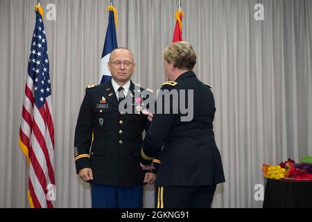 Col. Billie Heiser is presented an award by Maj. Gen. Tracey Noris, the Adjutant General of the Texas National Guard, During his retirement ceremony. Stock Photo
