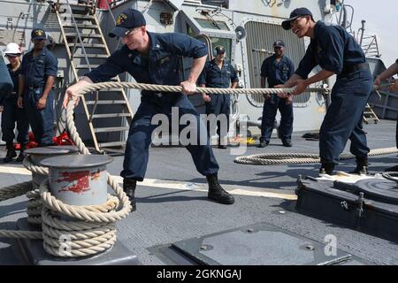 ROTA, Spain (June 5, 2021) Sonar Technician (Surface) 2nd Class Trevor Colley, left, and Sonar Technician (Surface) Seaman Peoukinik Than, assigned to the Arleigh Burke-class guided-missile destroyer USS Ross (DDG 71), double up a mooring line as the ship pulls into port in Rota, Spain, June 5, 2021. Ross, forward-deployed to Rota, is on patrol in the U.S. Sixth Fleet area of operations in support of regional allies and partners and U.S. national security interests in Europe and Africa. Stock Photo