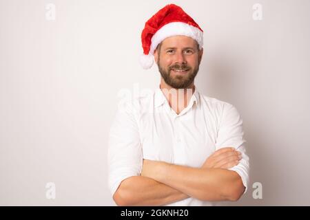Young handsome man wearing santa claus hat over isolated white background. Stock Photo