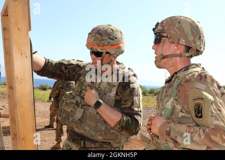 Soldiers assigned to Headquarters and Headquarters Company, 1st Battalion, 102nd Infantry Regiment (Mountain), 86th Infantry Brigade Combat Team zero their assigned M-4 rifle during a zero range in Djibouti, June 6, 2021. Zeroing a weapon creates accuracy, ensuring that the bullet fired from the weapon follows the expected trajectory with the respect to the shooter's line of sight. Stock Photo