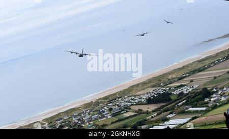 C-130J Super Hercules aircraft assigned to Ramstein Air Base, Germany, fly in formation in French airspace during the 77th anniversary of D-Day on June 6, 2021. Six C-130s assigned to the 37th Airlift Squadron conducted flyovers during several ceremonies commemorating the anniversary of D-Day. Stock Photo