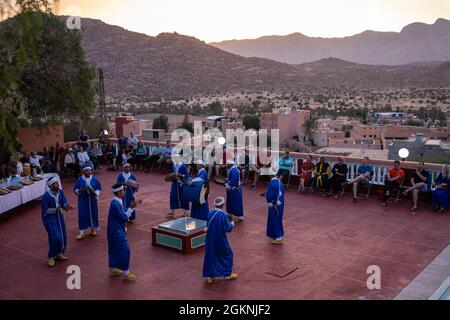 Moroccan dancers perform traditional Berber folk music during a welcome ceremony in Tafraoute, Morocco, for service members on June 6, 2021. African Lion 2021 is U.S. Africa Command's largest, premier, joint, annual exercise hosted by Morocco, Tunisia, and Senegal, 7-18 June. More than 7,000 participants from nine nations and NATO train together with a focus on enhancing readiness for U.S. and partner nation forces. AL21 is multi-domain, multi-component, and multinational exercise, which employs a full array of mission capabilities with the goal to strengthen interoperability among participant Stock Photo