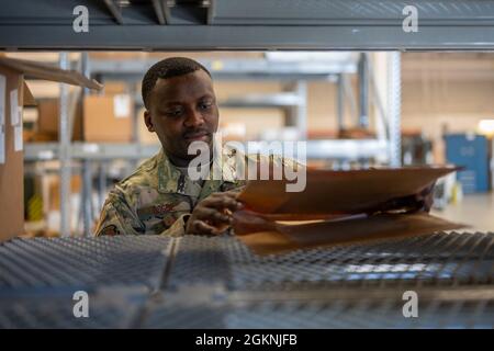 Staff Sergeant Salem Dogbe, Individual Equipment Element, 168th Wing Logistics Readiness Squadron, crosschecks stock numbers on an inventory item at Eielson Air Force Base, Alaska, June 6th, 2021. LRS is tasked with ensuring the Airmen of the 168th Wing, Alaska Air National Guard, are supplied with the equipment and clothing they require for mission success, especially in the arctic environment of Alaska. Stock Photo