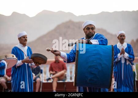 Moroccan dancers perform traditional Berber folk music during a welcome ceremony in Tafraoute, Morocco for service members on June 6, 2021. African Lion 2021 is U.S. Africa Command's largest, premier, joint, annual exercise hosted by Morocco, Tunisia, and Senegal, 7-18 June. More than 7,000 participants from nine nations and NATO train together with a focus on enhancing readiness for U.S. and partner nation forces. AL21 is multi-domain, multi-component, and multinational exercise, which employs a full array of mission capabilities with the goal to strengthen interoperability among participants Stock Photo