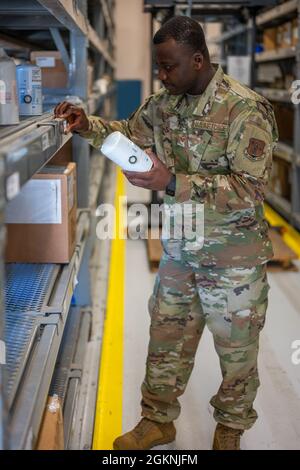 Staff Sergeant Salem Dogbe, Individual Equipment Element, 168th Wing Logistics Readiness Squadron, crosschecks stock numbers on an inventory item at Eielson Air Force Base, Alaska, June 6th, 2021. LRS is tasked with ensuring the Airmen of the 168th Wing, Alaska Air National Guard, are supplied with the equipment and clothing they require for mission success, especially in the arctic environment of Alaska. Stock Photo