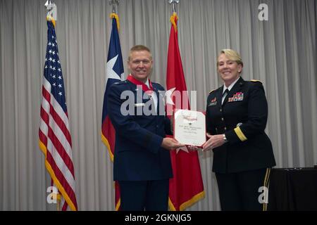 Mark Gaul is presented an award by Maj. Gen. Tracey Noris, the Adjutant General of the Texas National Guard, During his promotion to Brig. Gen. Stock Photo