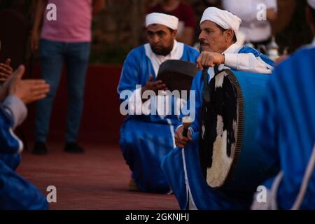 Moroccan dancers perform traditional Berber folk music during a welcome ceremony in Tafraoute, Morocco, for service members on June 6, 2021. African Lion 2021 is U.S. Africa Command's largest, premier, joint, annual exercise hosted by Morocco, Tunisia, and Senegal, 7-18 June. More than 7,000 participants from nine nations and NATO train together with a focus on enhancing readiness for U.S. and partner nation forces. AL21 is multi-domain, multi-component, and multinational exercise, which employs a full array of mission capabilities with the goal to strengthen interoperability among participant Stock Photo