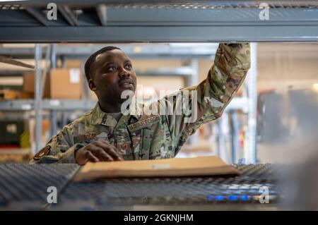 Staff Sergeant Salem Dogbe, Individual Equipment Element, 168th Wing Logistics Readiness Squadron, crosschecks stock numbers on an inventory item at Eielson Air Force Base, Alaska, June 6th, 2021. LRS is tasked with ensuring the Airmen of the 168th Wing, Alaska Air National Guard, are supplied with the equipment and clothing they require for mission success, especially in the arctic environment of Alaska. Stock Photo