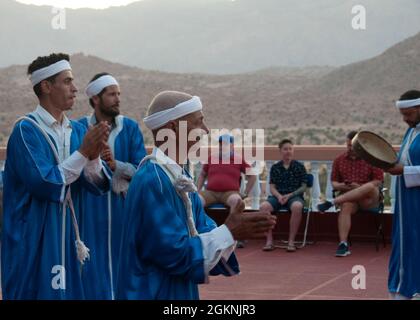 Moroccan dancers perform traditional Berber folk music during a welcome ceremony in  Tafraoute, Morocco for service members on June 6, 2021. African Lion 2021 is U.S. Africa  Command’s largest, premier, joint, annual exercise hosted by Morocco, Tunisia, and Senegal, 7-18 June. More than 7,000 participants from nine nations and NATO train together with a focus on enhancing readiness for us and partner nation forces. AL21 is multi-domain, null-component, and multinational exercise, which employs a full array of mission capabilities with the goal to strengthen interoperability among participants. Stock Photo