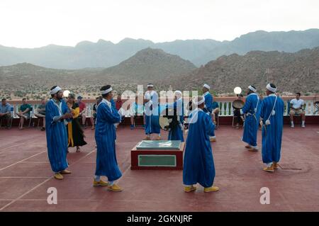 Moroccan dancers perform traditional Berber folk music during a welcome ceremony in Tafraoute, Morocco for service members on June 6, 2021. African Lion 2021 is U.S. Africa Command’s largest, premier, joint, annual exercise hosted by Morocco, Tunisia, and Senegal, 7-18 June. More than 7,000 participants from nine nations and NATO train together with a focus on enhancing readiness for us and partner nation forces. AL21 is multi-domain, null-component, and multinational exercise, which employs a full array of mission capabilities with the goal to strengthen interoperability among participants. Stock Photo