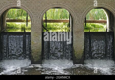 Detail of a historic weir  that feeds a canal with water from a river Stock Photo