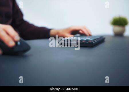 Side view of player using mouse and keyboard. Professional computer game playing, esport business and online world concept. Stock Photo