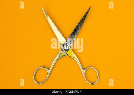 Very sharp retro professional tailor scissors on yellow background Stock Photo