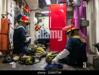 Sailors assigned to USS Gerald R. Ford (CVN 78) inventory repair kits during a general quarters drill, June 8, 2021. Ford is underway in the Atlantic Ocean conducting Full Ship Shock Trials (FSST). The U.S. Navy conducts shock trials of new ship designs using live explosives to confirm that our warships can continue to meet demanding mission requirements under the harsh conditions they might encounter in battle. Stock Photo