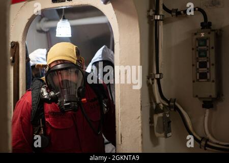 A damage control party works in the after cabin of Dido-class cruiser ...