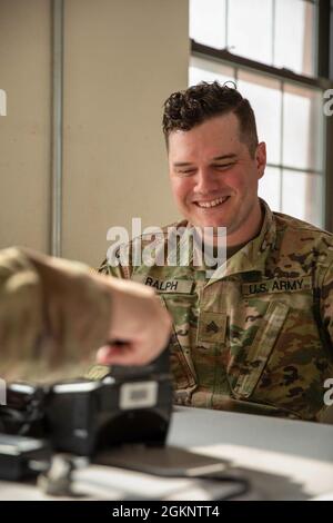 A Soldier prepares to enter fingerprint data into a biometrics scanner during Panther Strike at Camp Williams, Utah, June 8, 2021. Panther Strike is an elite military intelligence exercise organized by the 300th Military Intelligence Brigade designed to provide all-source training to counter hybrid threats in a technological and challenging environment. Stock Photo