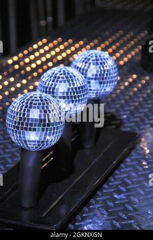 Vertical shot of three disco balls in the backstage Stock Photo