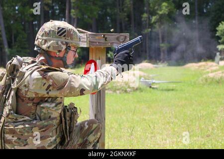 Pfc. Kyles Voyles, a 35M, Human Intelligence Officer assigned to 9th Brigade Engineer Battalion, 2nd Armor Brigade Combat Team, 3rd Infantry Division, fires from the kneeling position during the M9 pistol qualification at Small Arms Range Yankee, Fort Stewart, Georgia June 9, 2021. Voyles, a native of Corydon, Indiana, qualified as expert on the M9 pistol, shooting 28 out of 30 targets. Stock Photo