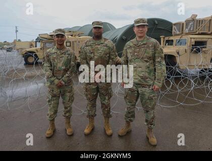 U.S. Army Reserve Soldiers Maj. Mohammed Rashed (left), Maj. Geoffrey Williams (middle), and Major Wonny Kim (right) stand at the site of the V Corps Defender Europe 21 command post exercise June 11, 2021 at Fort Knox, Kentucky. The three Reserve Officers from the 75th Innovation Command supported V Corps and their missions by providing AI technology to maintain V Corps mission ready standards. Stock Photo