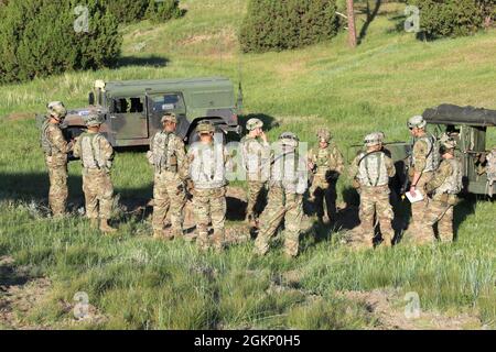 U.S. Army National Guard soldiers assigned to 1st Battalion, 161st Field Artillery Regiment receive a mission briefing for an M109A6 Paladin training lane during XCTC 21-05 at the Camp Guernsey Joint Training Center, Wyoming, June 9, 2021. The paladin training scenarios included reconnaissance operations, controlling a field artillery movement, establishing an operations center and firing capabilities. Stock Photo