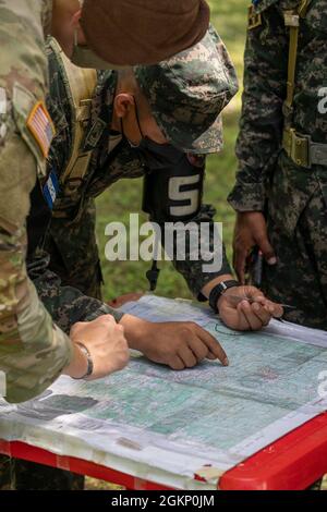 U.S. Army Sgt Seth Wilbourne, forward observer for Field Artillery Advisor Team 1412, 5th Battalion, 1st Security Force Assistance Brigade, observes members of the Honduran Armed Forces Army participate in a field artillery training on 4th Artillery Battalion, Choluteca, Department of Honduras, June 9, 2021. The U.S. Army provides further training to enhance the skillsets of foreign armed forces. Stock Photo