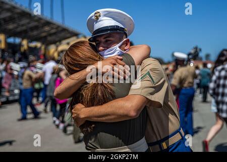 A new Marine of Delta Company, 1st Recruit Training Battalion, is welcomed by a loved one following a graduation ceremony at Marine Corps Recruit Depot, San Diego, June 10, 2021. As recruits, their only means of contact were through letters during their 13-week training cycle. Stock Photo
